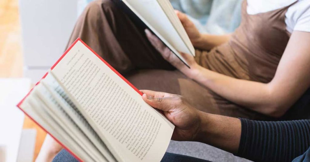 Man Reading Book Beside Woman Reading Book