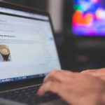 Person Holding Turned-on Silver Laptop Computer