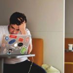 Man in White Shirt Using Macbook Pro