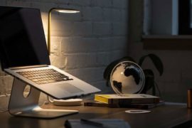 Macbook Pro on Stand Beside Desk Globe