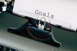 Green Typewriter on Brown Wooden Table