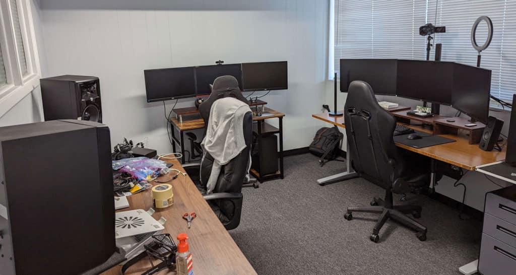 Three tables setup with two computer stations for work.