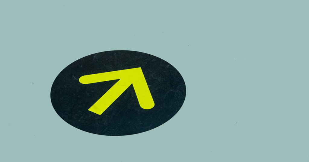 Yellow arrow on blue floor for directional guide