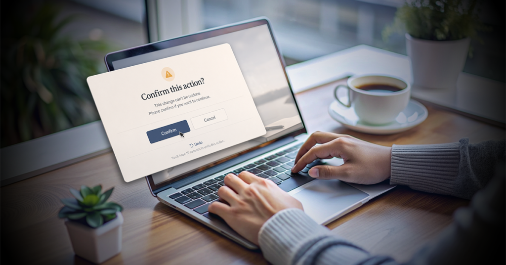 "Person using a laptop with a confirmation dialog on screen asking to confirm an action, featuring confirm, cancel, and undo options.